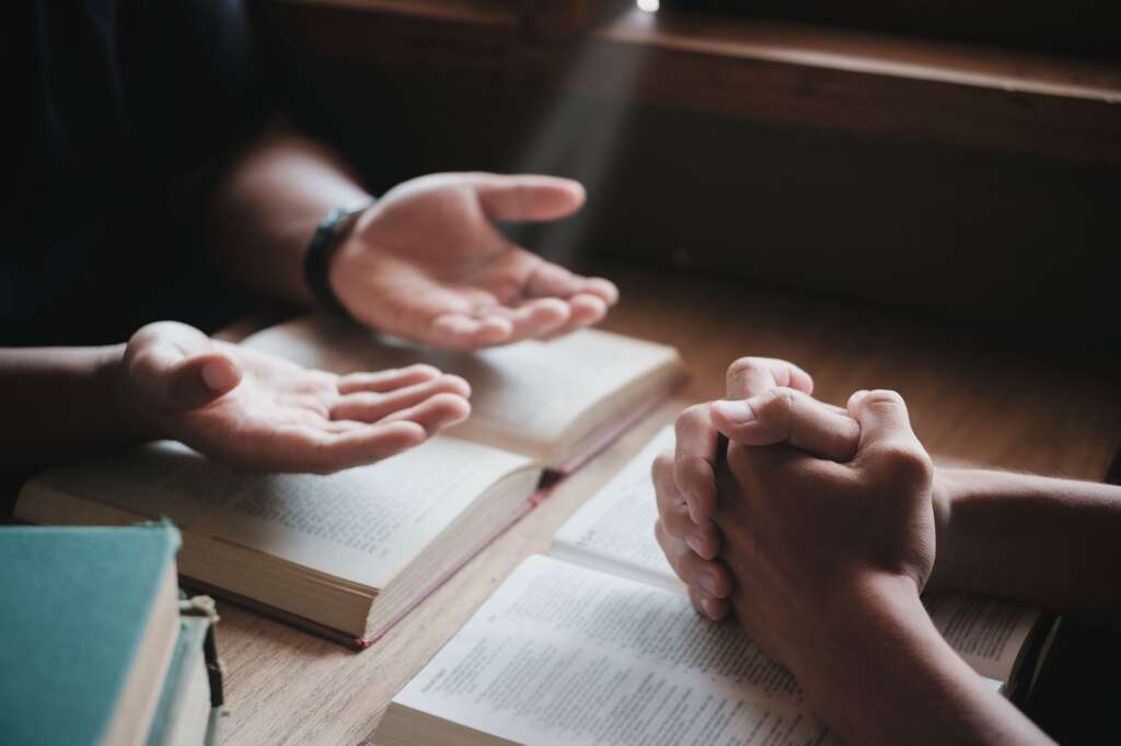 Christians are congregants join hands to pray and seek the blessings of God.